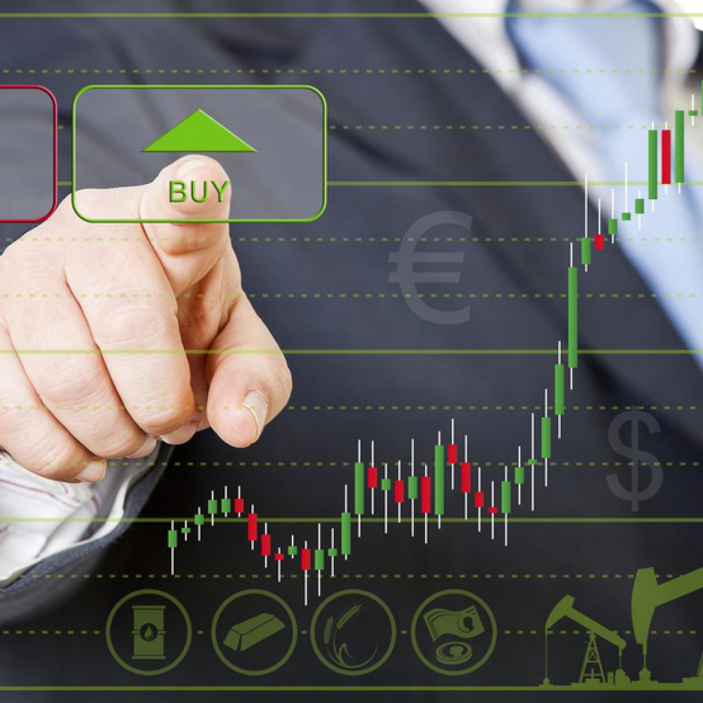 A closeup of a stock trader hitting a green arrow on a stock chart