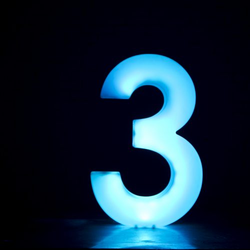 the number 3 in blue with a black background
